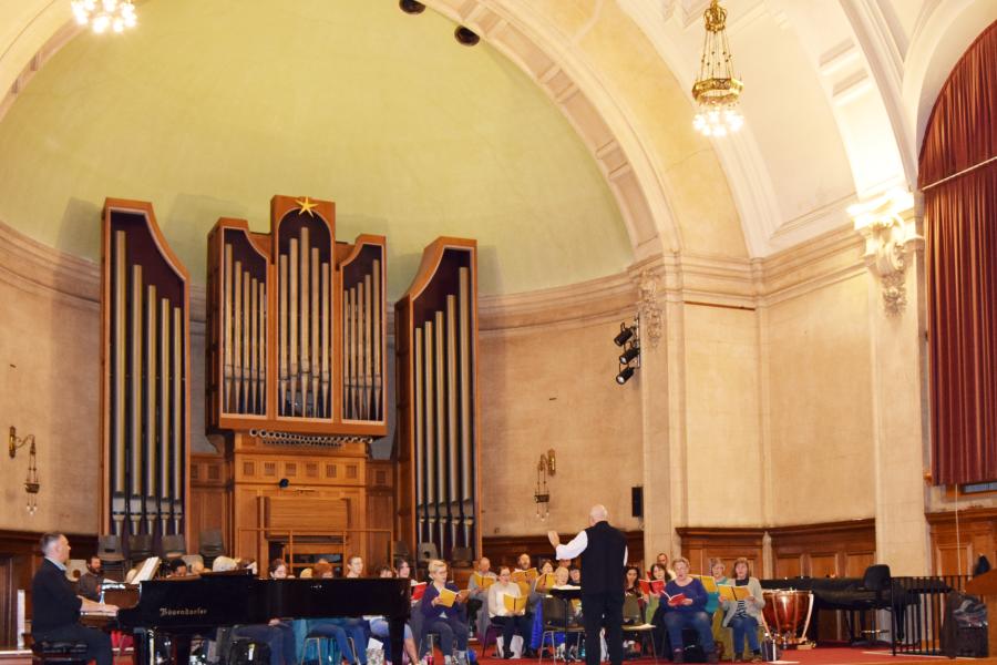 a group of people rehearsing for a choral concert