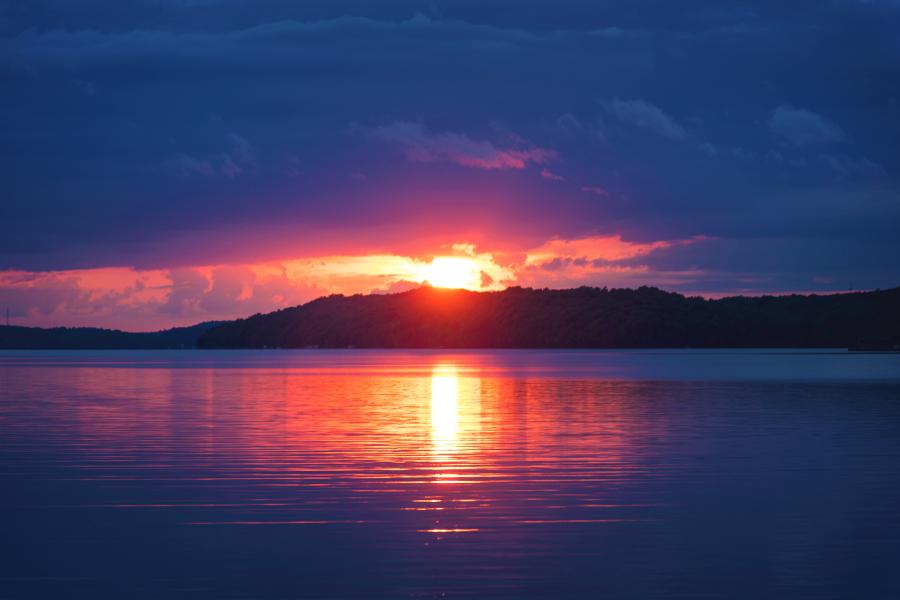 a landscape image of the sea,mountain and a sunset 