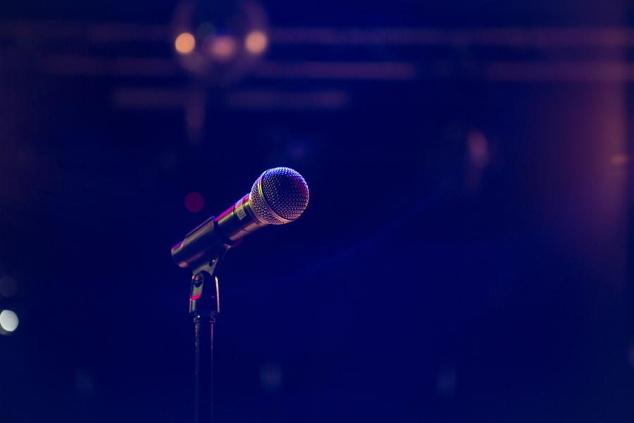 microphone on stand with dark blurred event background