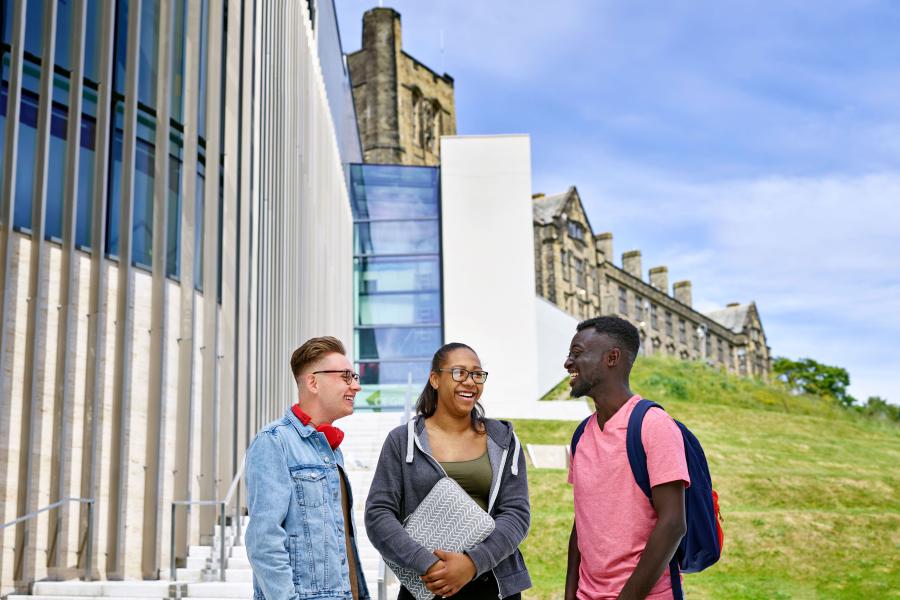 a group of students discussing outside Pontio 