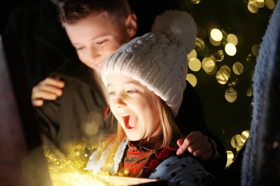 Little girl and boy holding a box that's sparkling