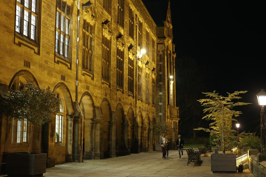 Main Arts Building with family running outside 