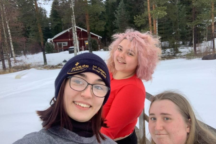 Group of students with a snowy forest backdrop