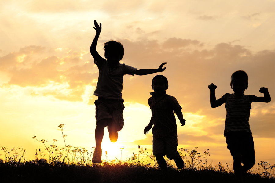 Children playing at sunset/dawn