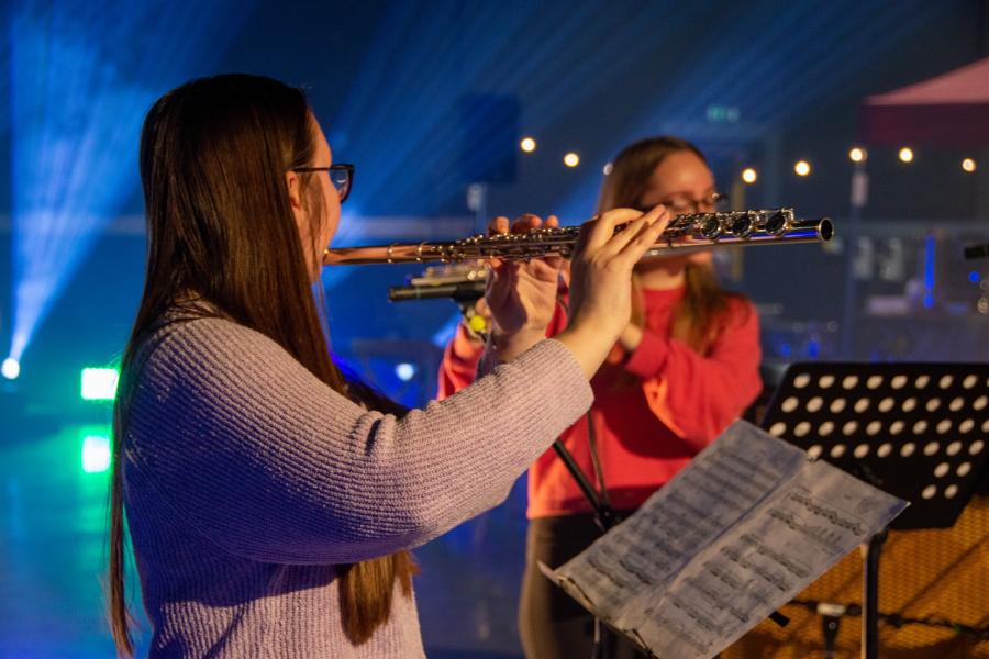 close up of two people playing the flute