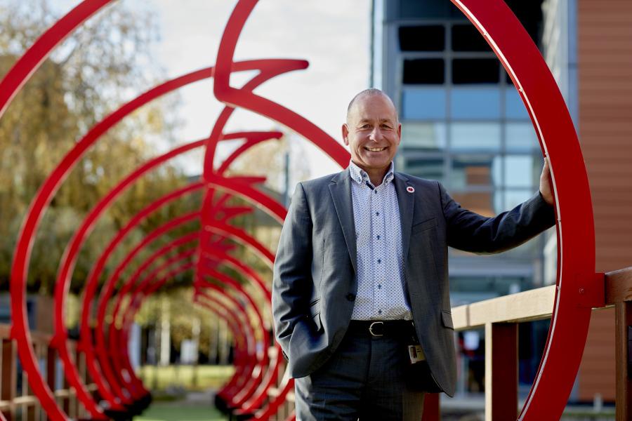 Paul Morton, Head of Defence at Vodafone UK, on a bridge shaped like the Vodafone logo