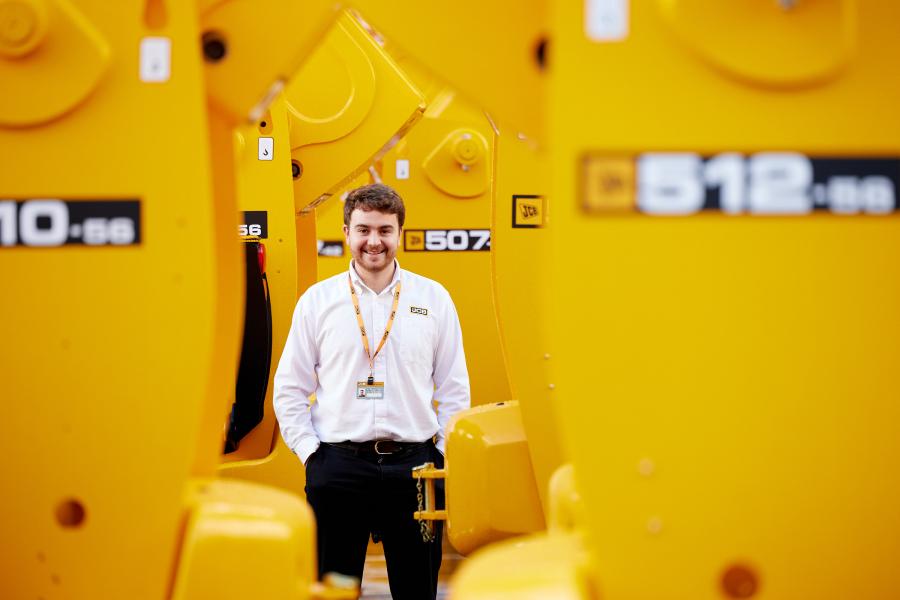 Charlie Small, Product Design graduate, with JCB machinery