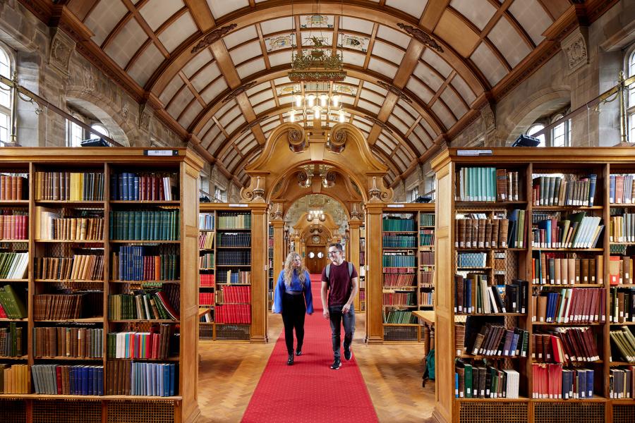 Two students walking through Shankland Library