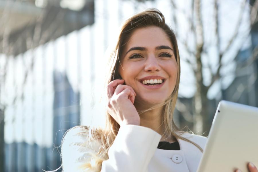 An image of you woman holding a woman holding a phone. Chatting and smiling.