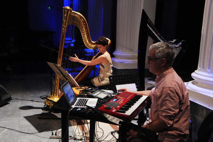 Two people playing instruments in a studio