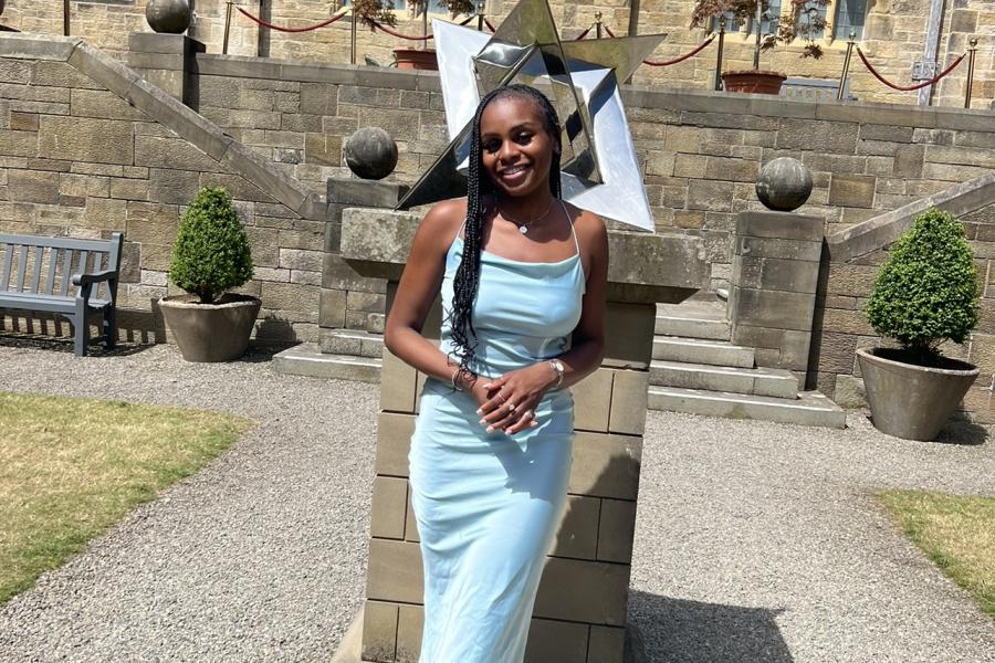 Natalia Kele Ehenulo smiling to camera in the Inner Quad at Bangor University