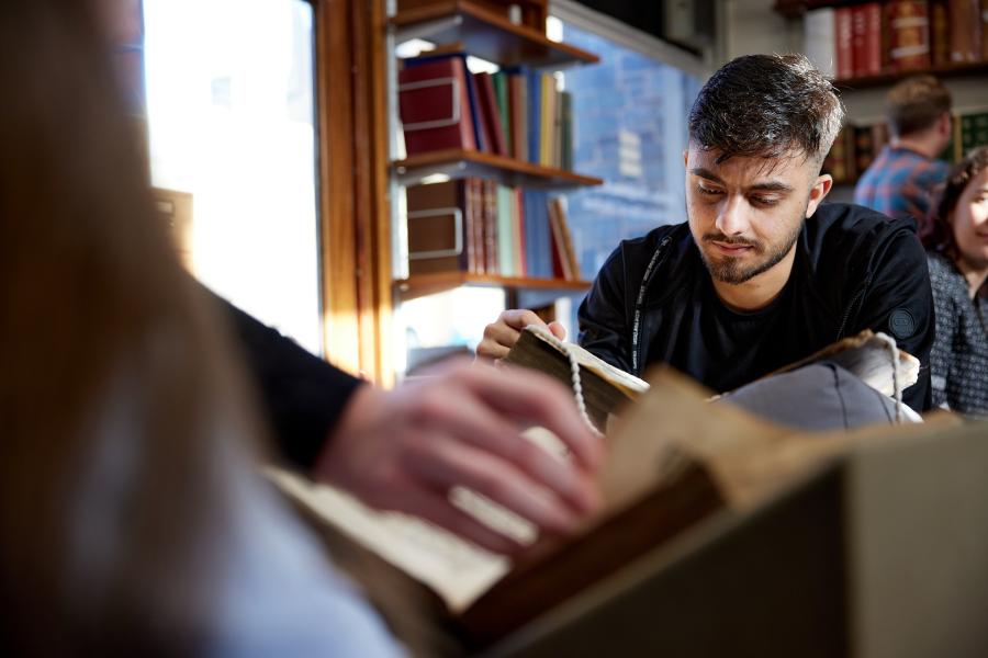 A student looking through the archives at the University