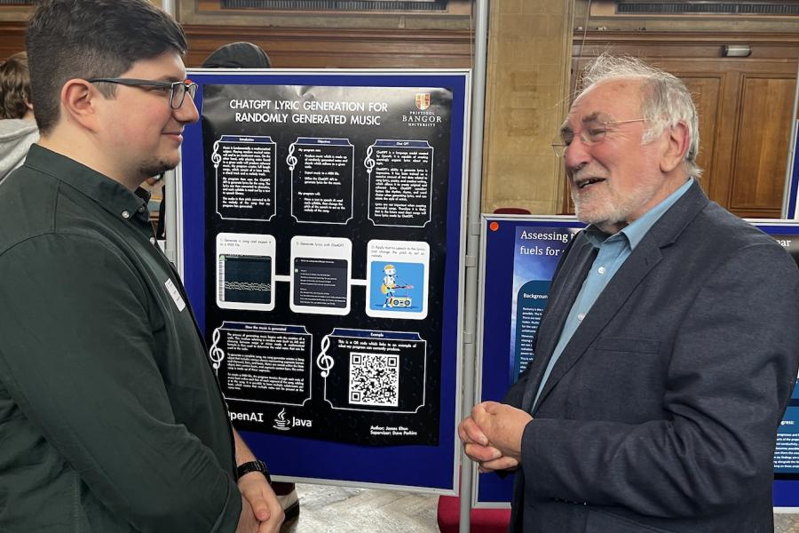 Mr James Elton (BSC Computer Science) speaking with the Chancellor Sir Robin Williams