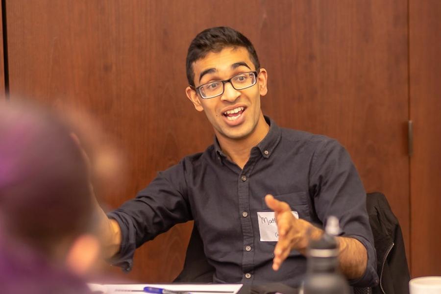 Matt Lobo talking to group of people around the table 