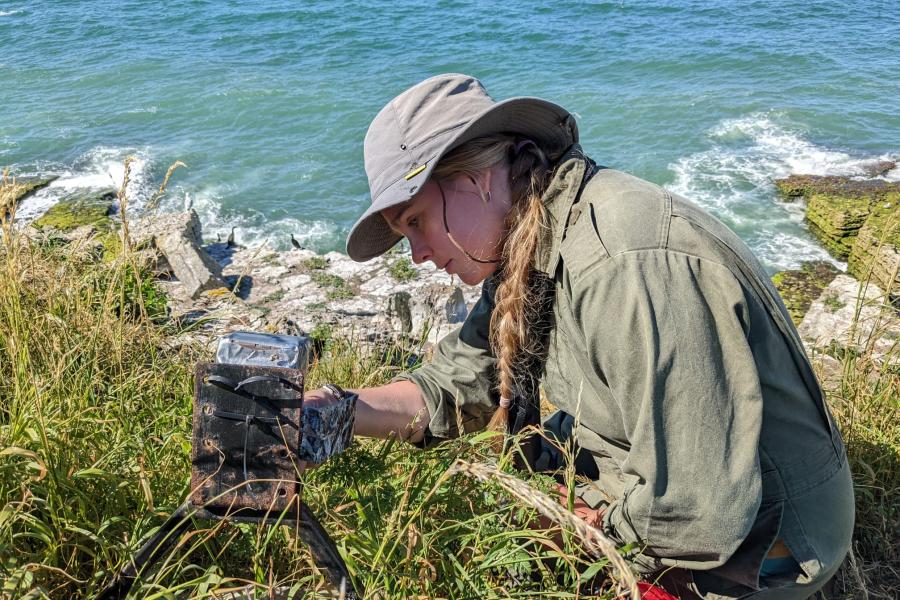 Claire Carrington on a shore performing research.