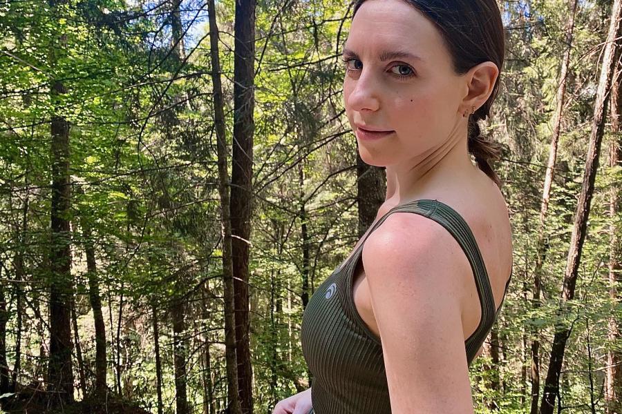 Image of member of research staff, Elena Cini standing in front of trees