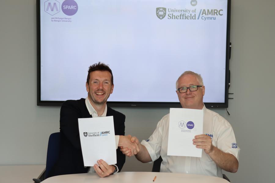 Pryderi ap Rhisiart, Managing Director of M-SParc and Andrew Martin, head of food and drink at AMRC Cymru exchange agreements.
