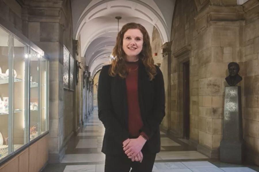 Sara Closs-Davies smiling to camera in prof corridor 