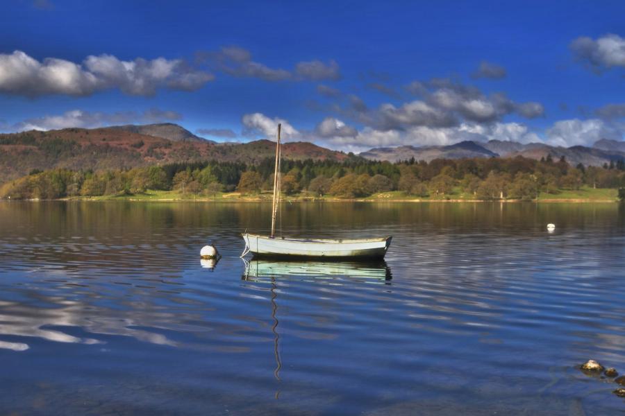 A small boat sits on lake Windermere