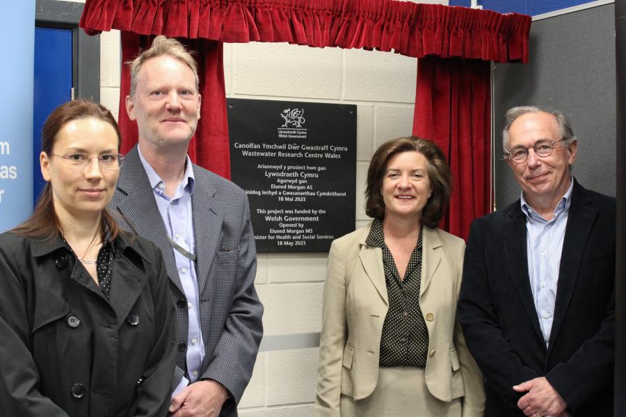 Group of people standing in front of a plaque