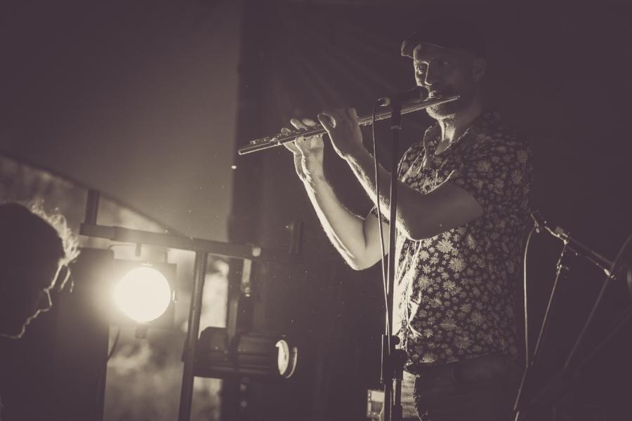 Black and white image of a man playing the flute