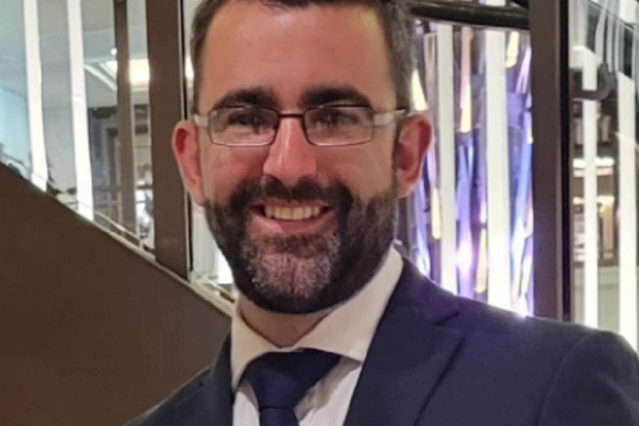 Edward Roberts, wearing glasses and a dark suit an tie