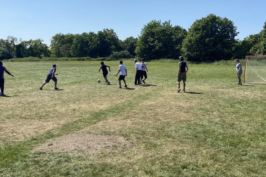 Staff and students playing football