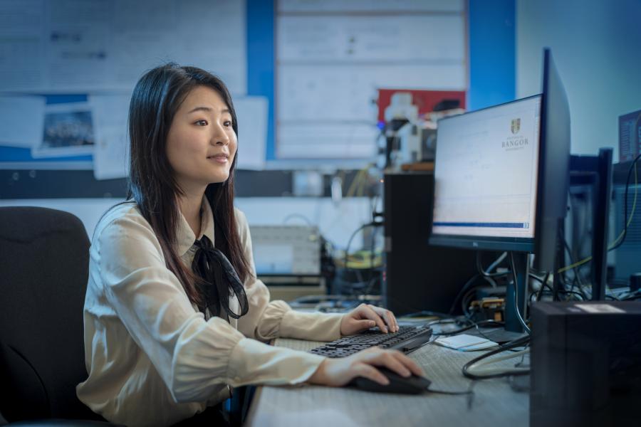 woman sitting at computer desk
