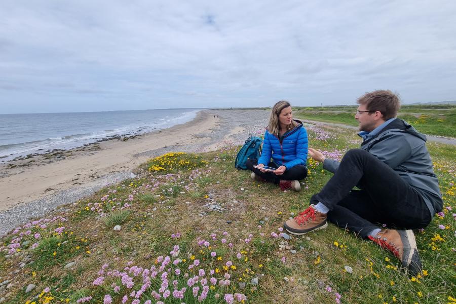 Image of Dr Sophie Ward at Dinas Dinlle being interviewed for a S4C documentary on climate change.