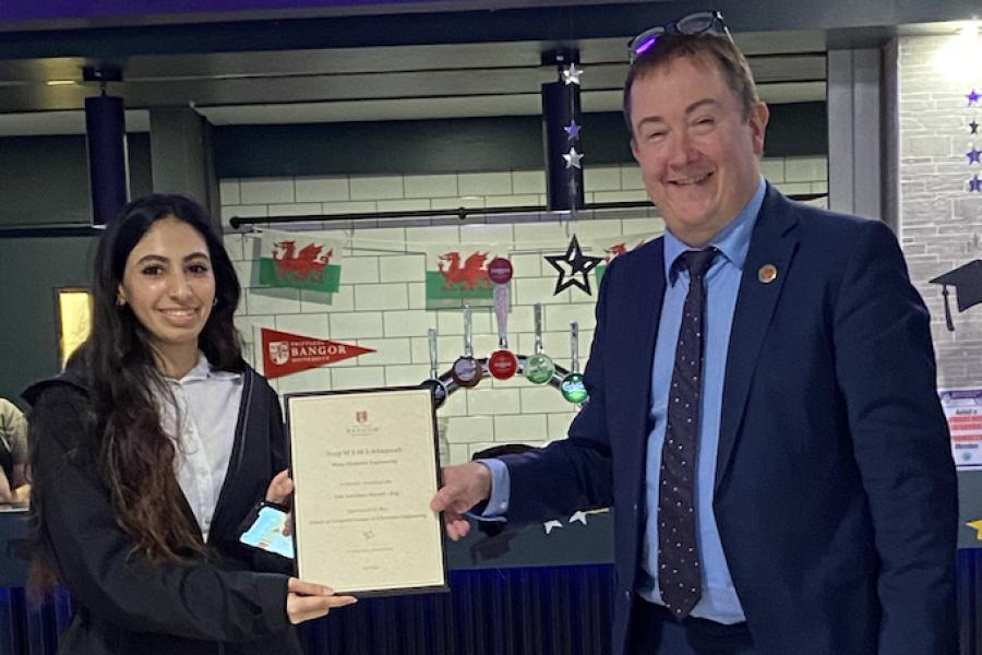 Miss Noof M S M S Alraqwah receiving her award from Dr Iestyn Pierce (Head of School)