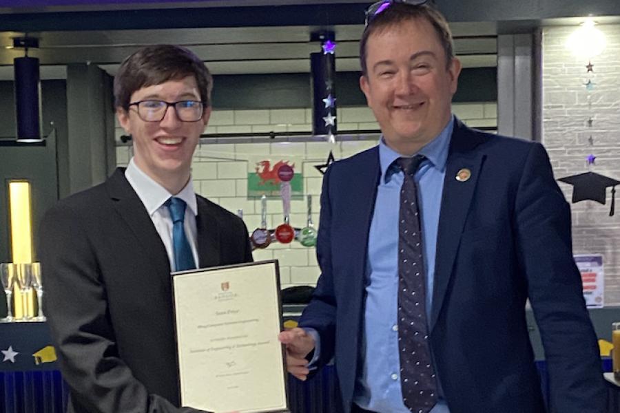 Sean Price receiving his award from Dr Iestyn Pierce (Head of School)
