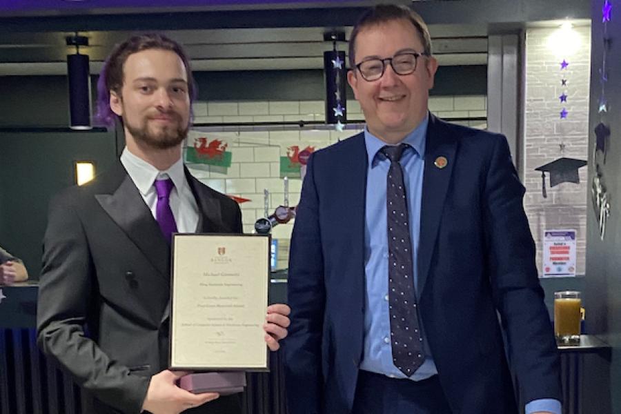 Michael Giombetti receiving his award from Dr Iestyn Pierce (Head of School)