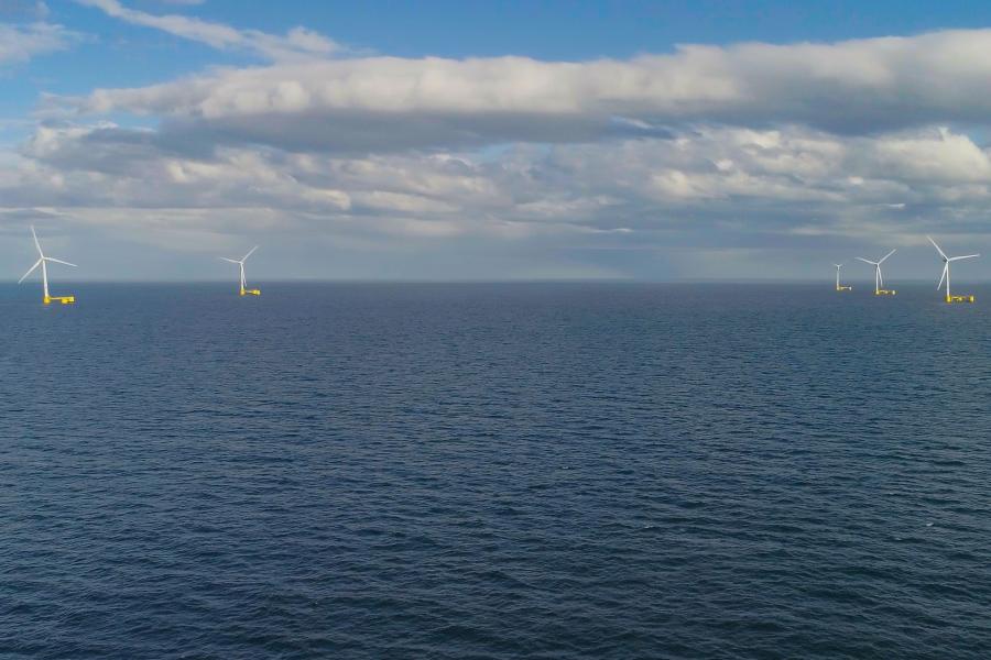 A long distance view of multiple offshore floating wind turbines
