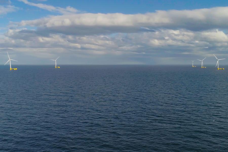  A long distance view of multiple offshore floating wind turbines