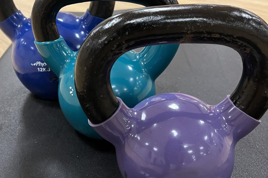 Three Kettle bells in a row, used in a kettlebell class
