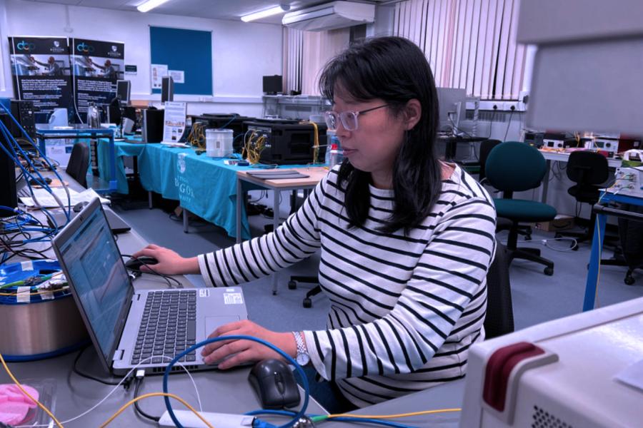 A female researcher working in the optical network lab