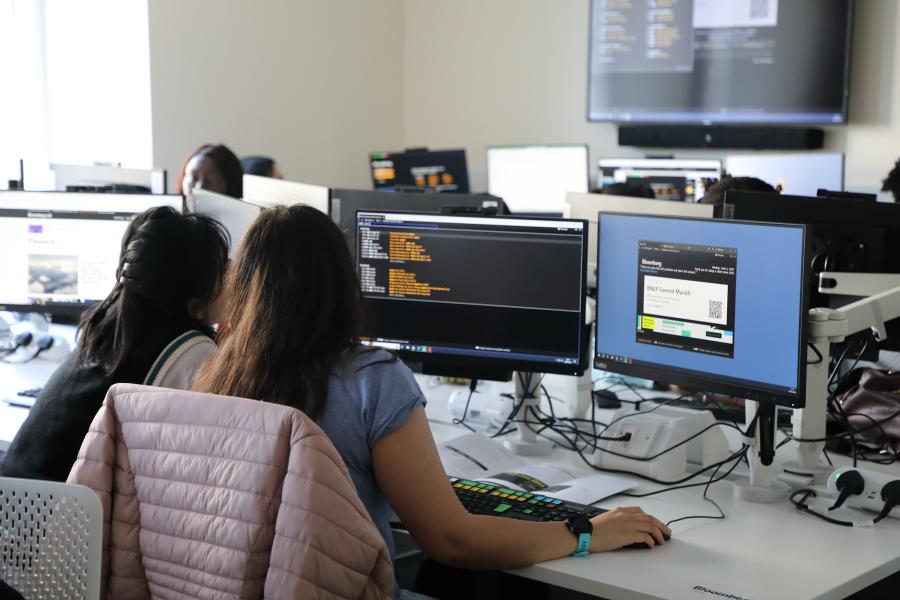 Two students looking at databases in the new trading floor