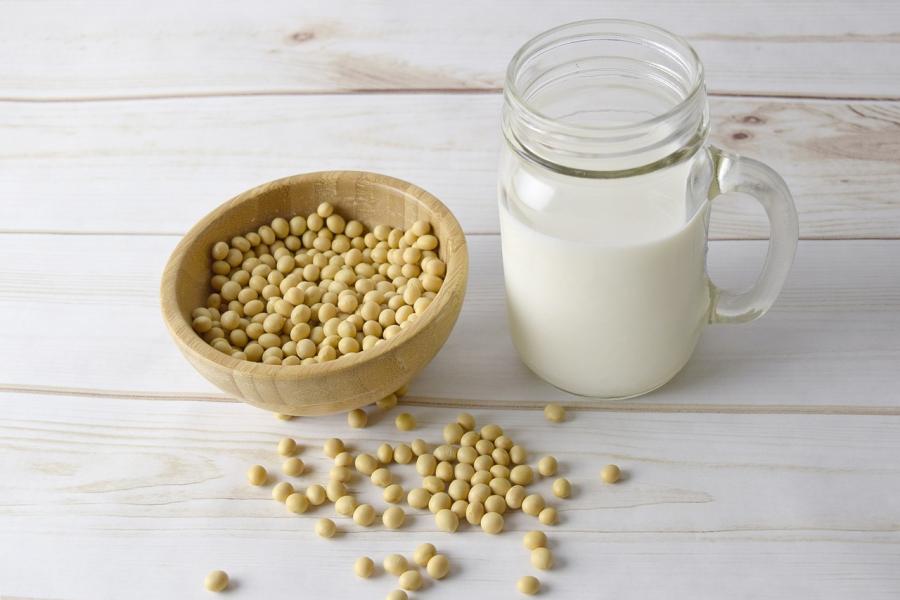 Abowl of sou beans and a glass of soy milk