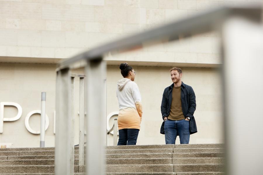 Two students chatting outside Pontio