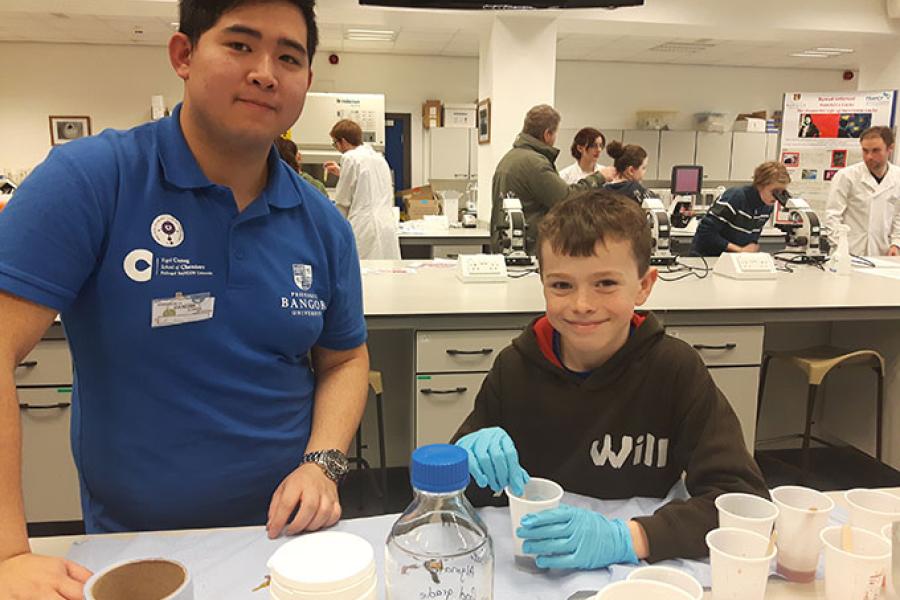 A student and child at a laboratory workshop at the Bangor Science Festival 