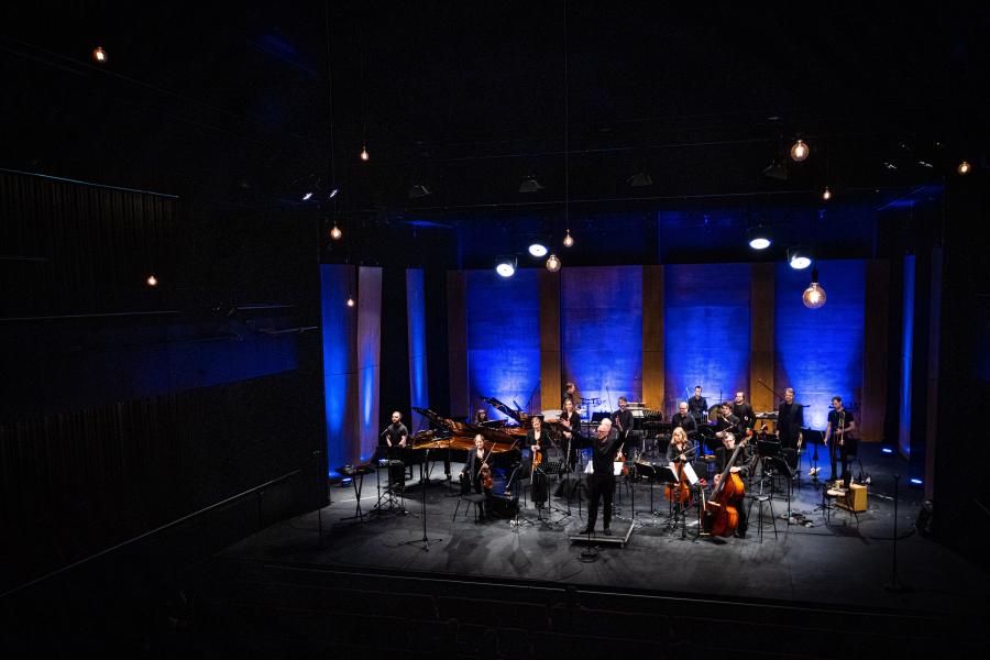 An orchestra playing on a stage 