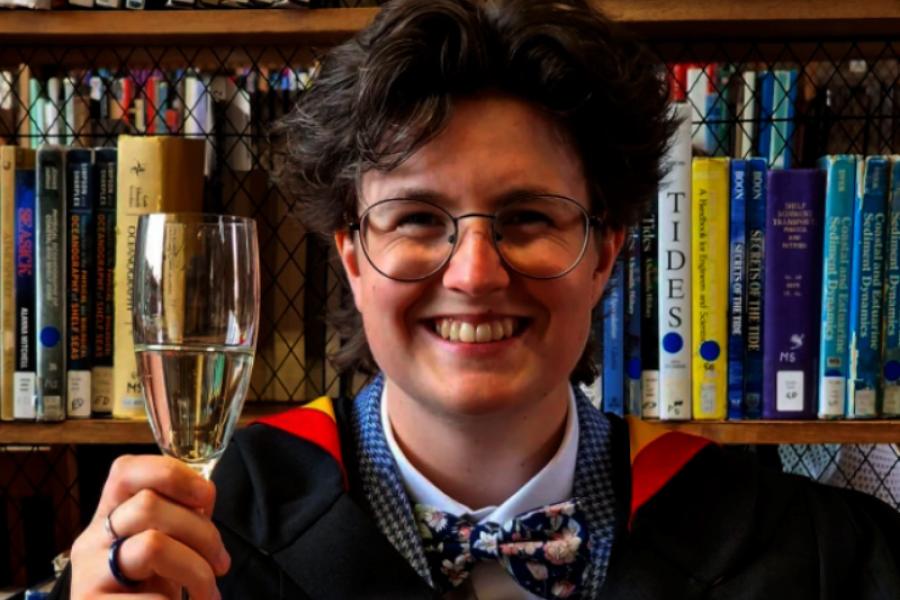 Beth Jones toasting with a glass of prosecco 