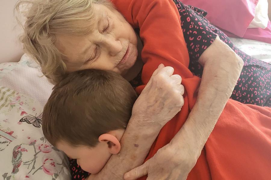 Elderly woman holding on to a child