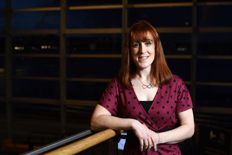 Woman looks into camera, smiling