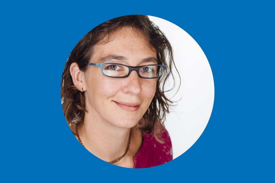 woman with dark wavy hair and glasses in circle with blue surround