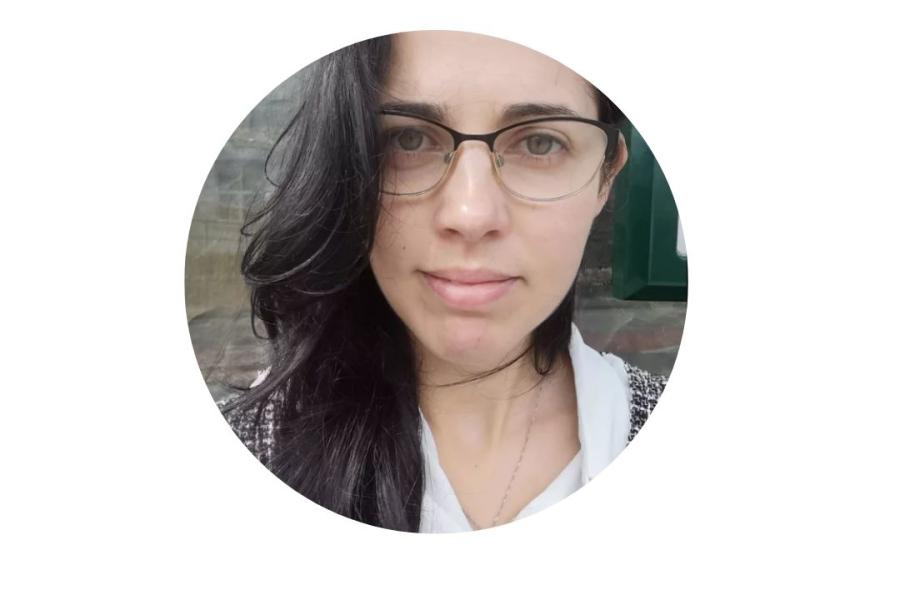 Woman with long dark hair and spectacles