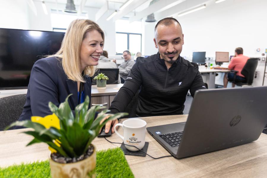 Two people looking at a computer