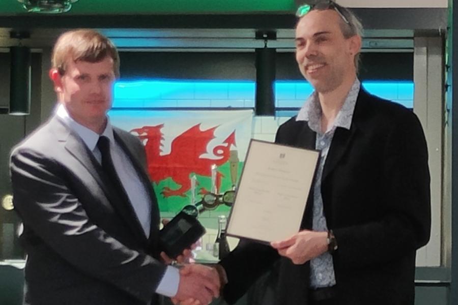 Robert Plaister receiving his award