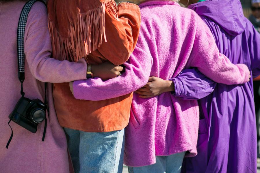 Picture of people's back holding each's others 