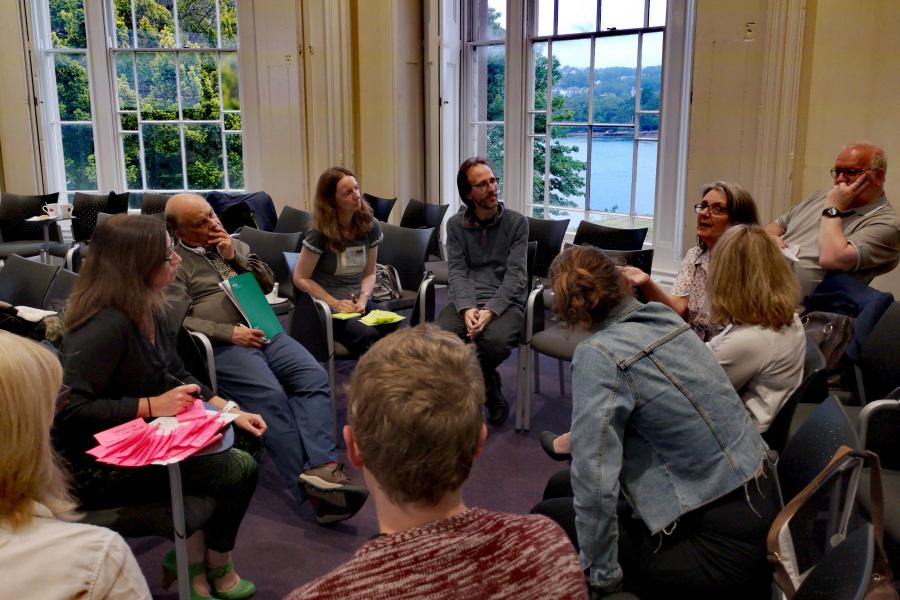 People sitting in a circle working collaboratively 
